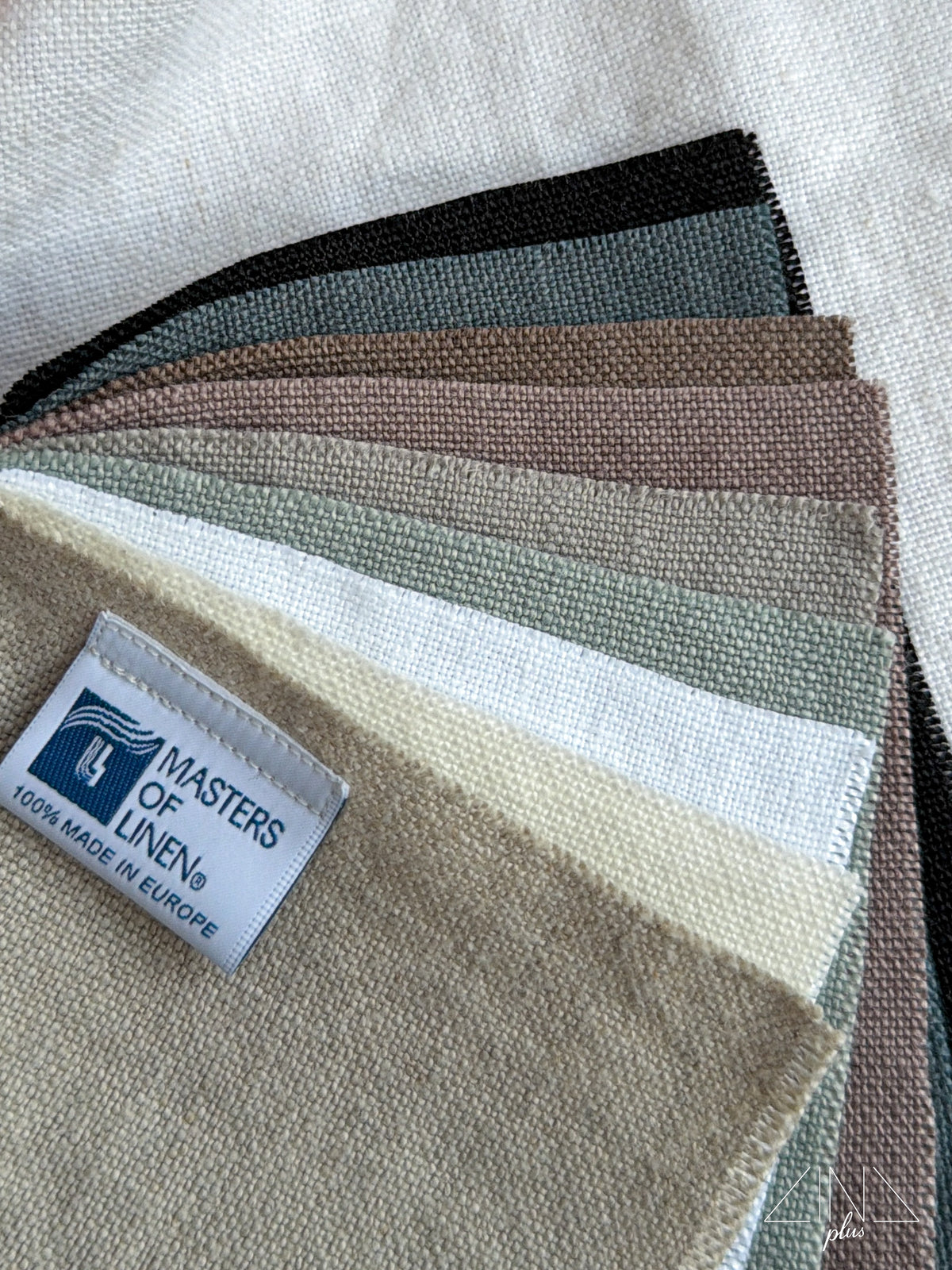 Linen samples CANAPO fanned in black, blue, brown, green, and cream colors