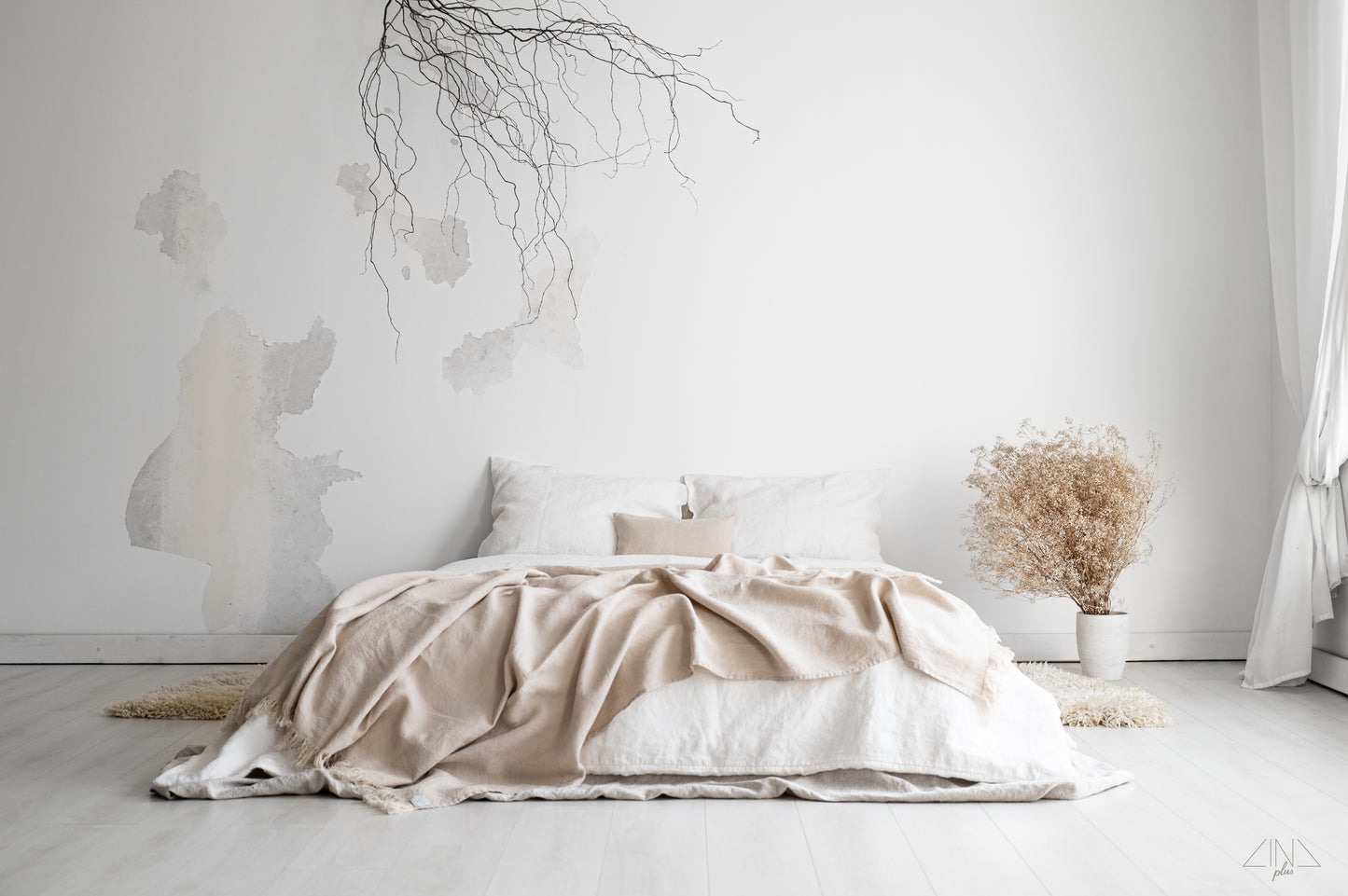 Heavy Weight Linen Throw with fringes in color Cream draped on a bed.