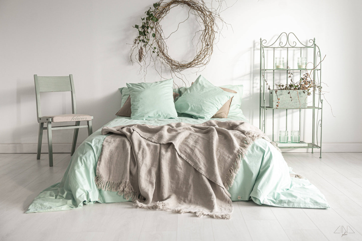 Heavy Weight Twill Linen Throw with fringes in natural flax color draped on a bed.