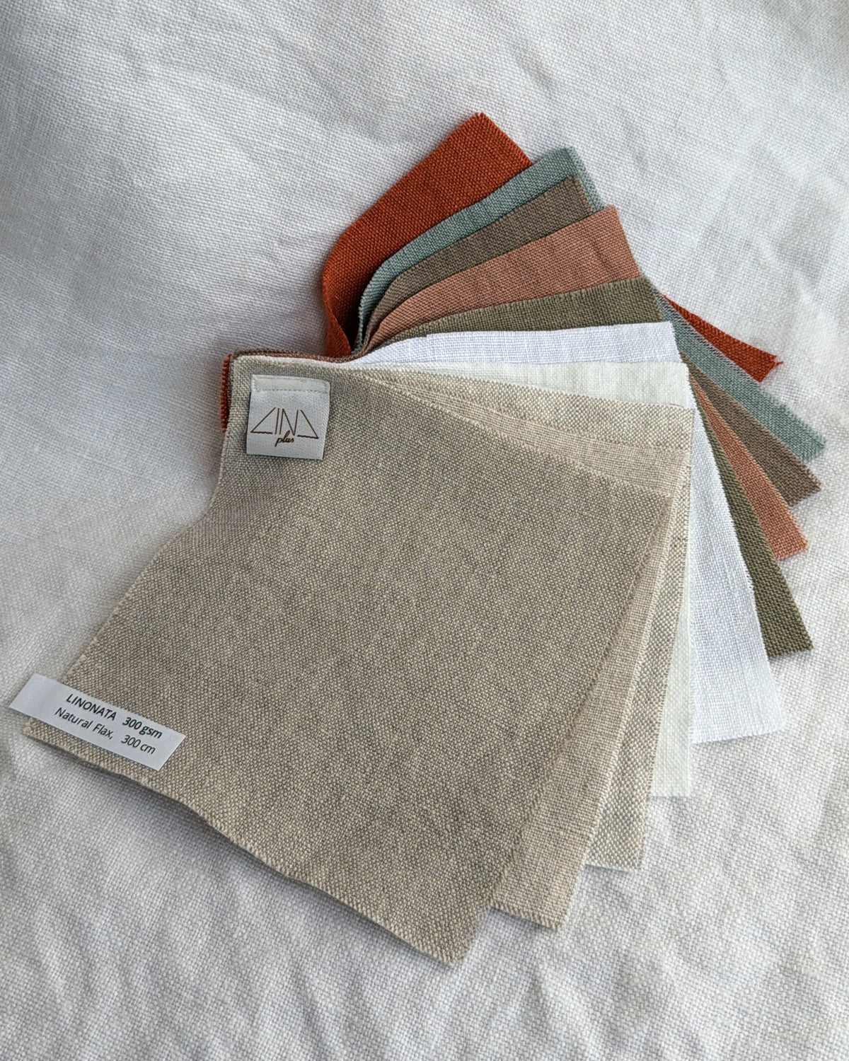 Linen Samples LINONATA in rust, gray, beige, pink, white, and green fanned display