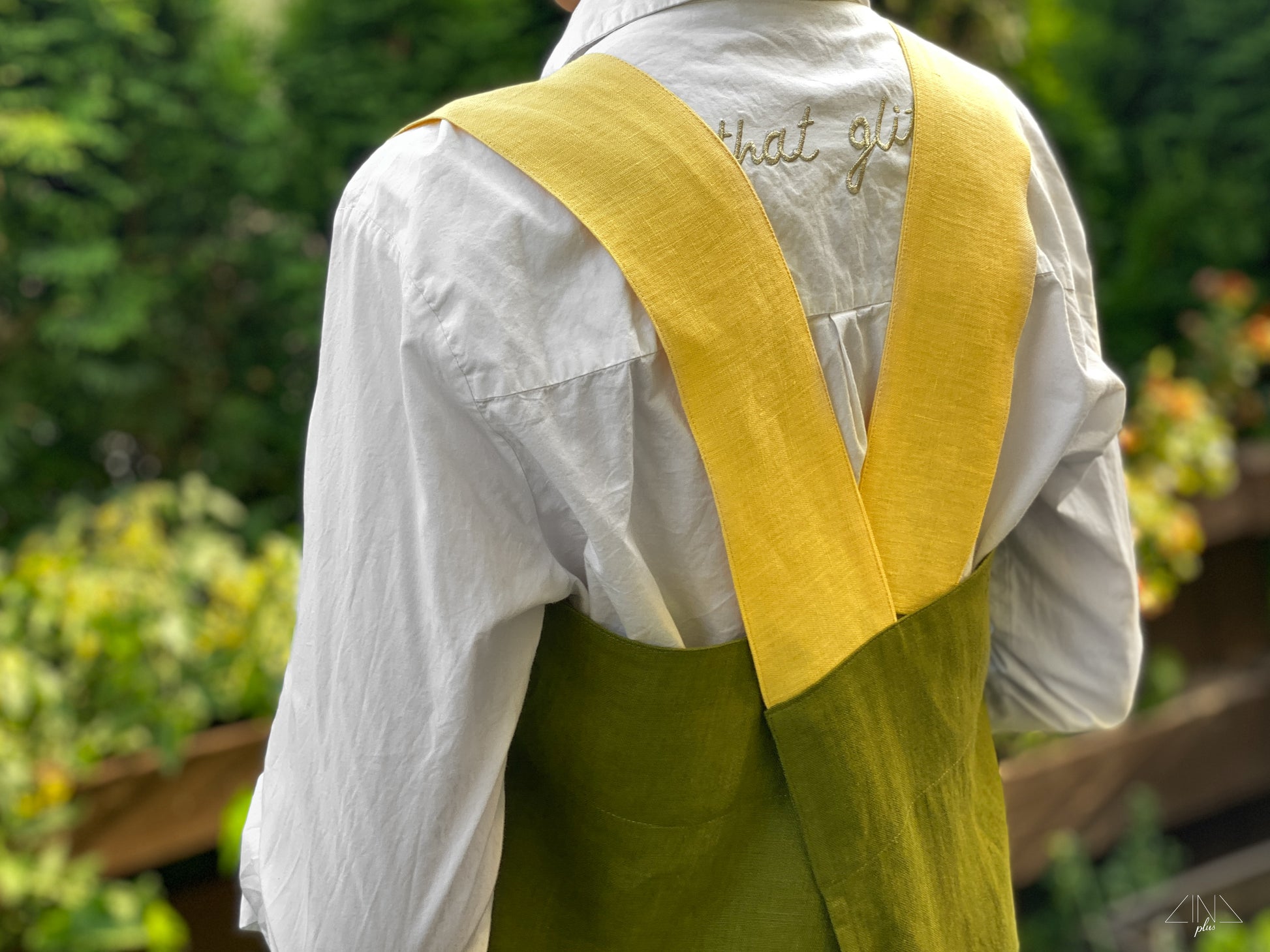 Bicolor Linen Pinafore Apron in Moss Green color with Yellow Pockets and Straps for gardening.