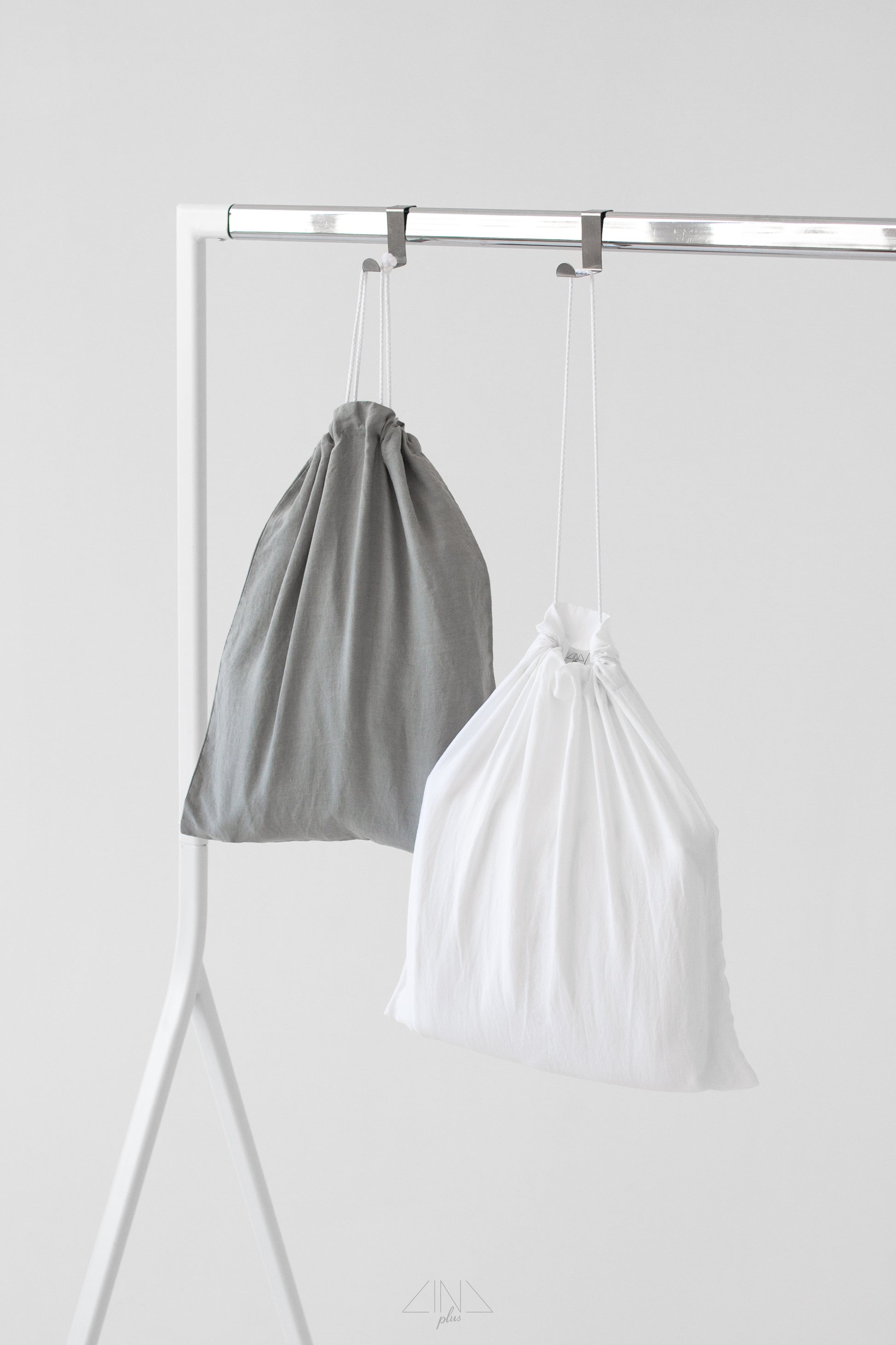 Medium weight linen laundry bags in white and perle grey colors.